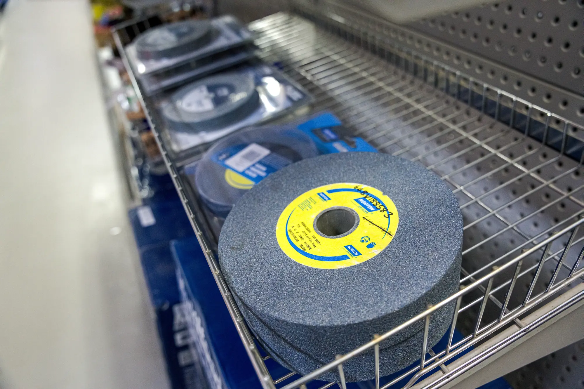 Grinding wheels stocked in a wire basket