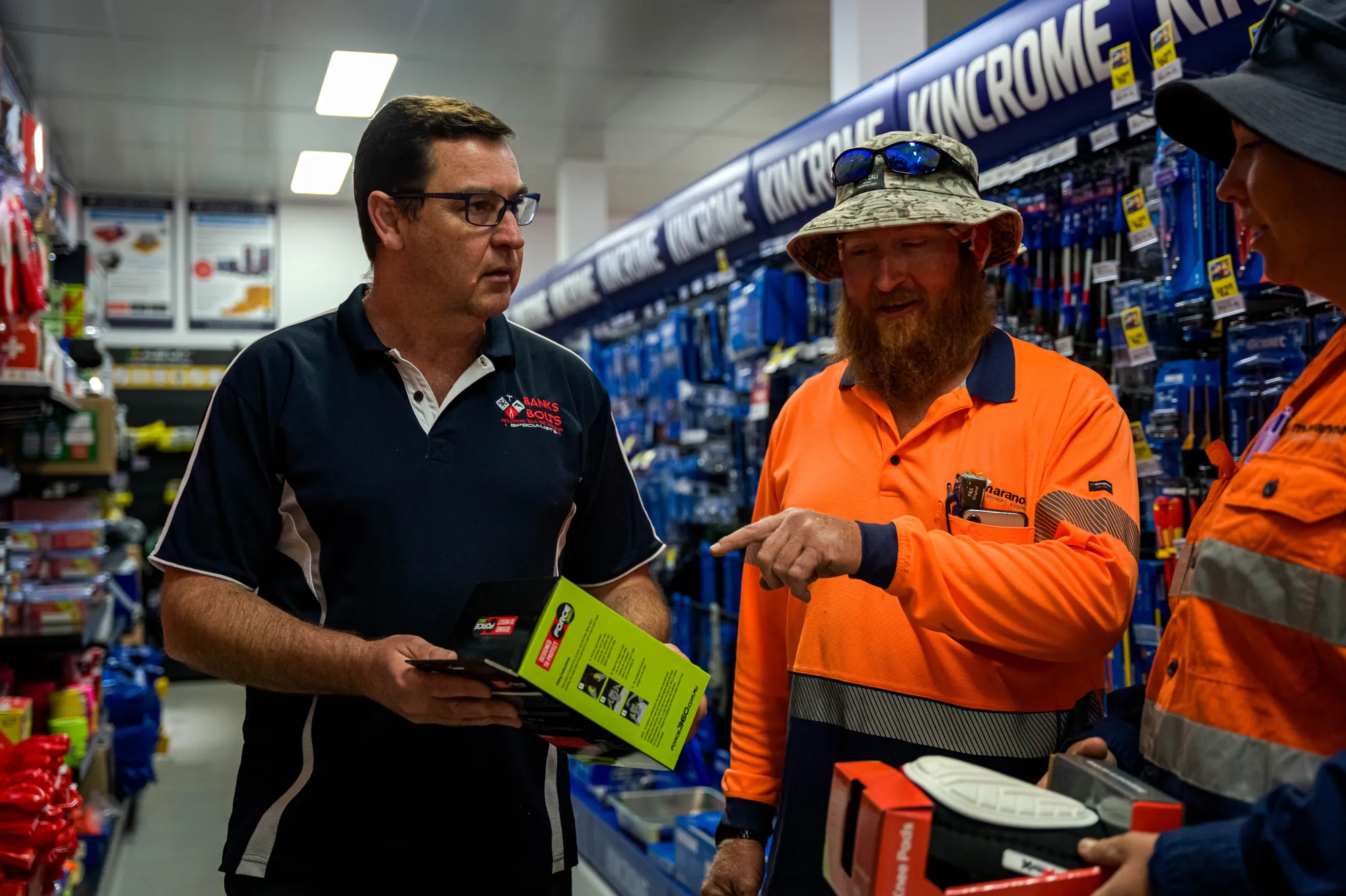 Staff member chatting with customers in the tools aisle